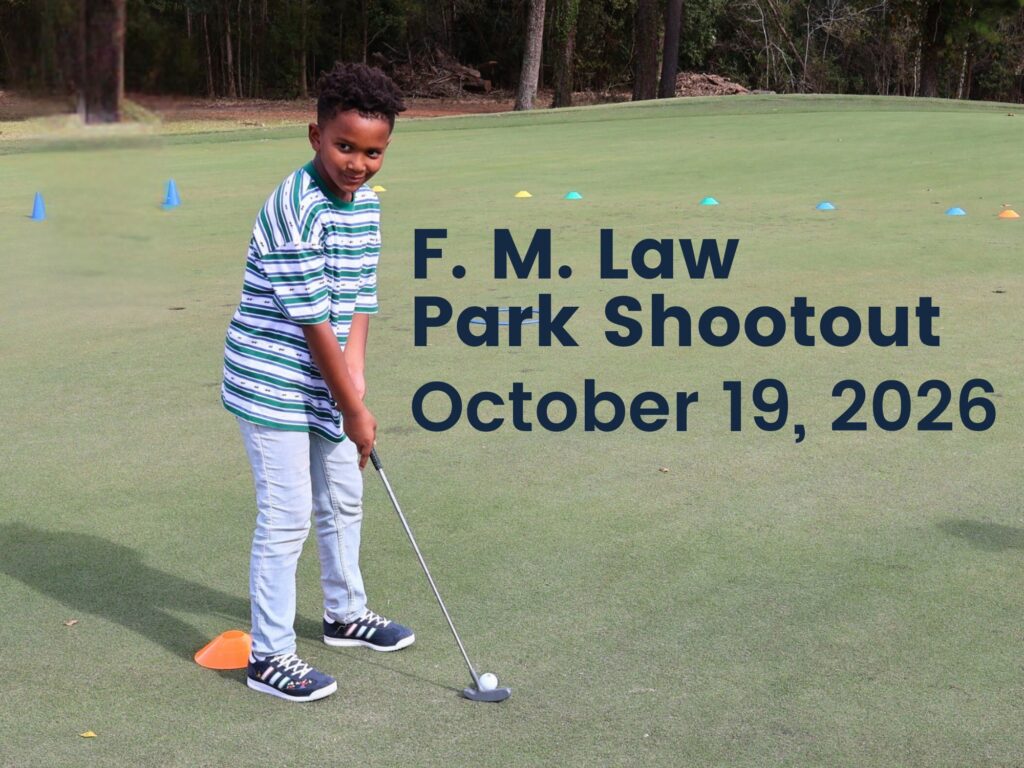 Young man on a putting green at F.M. Law Park Golf Course fundraiser tournament in Houston